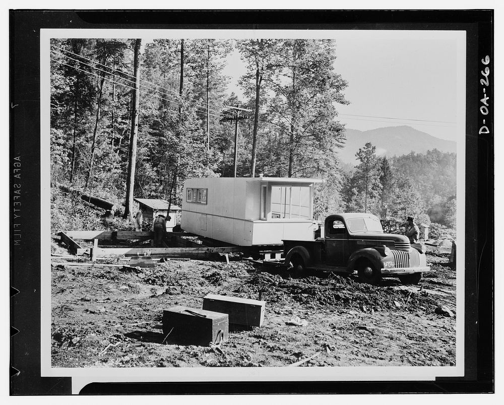 Defense housing. The first section of the Tennessee Valley Authority's (TVA) experimental trailer-house is backed up onto…