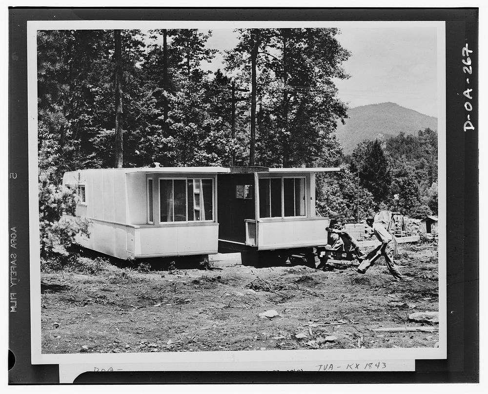 Defense housing. The second section of the experimental trailer-house is joined to the first section. The workmen will have…