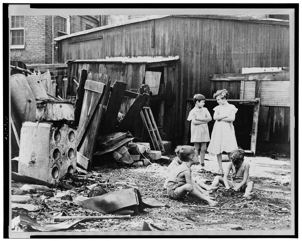 Slum children at play, Washington, D.C. Children in their backyard near the Capitol. This area inhabited by both black and…