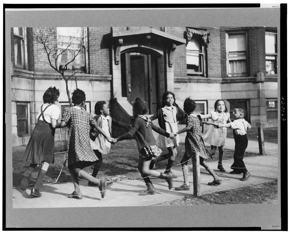 Children playing "ring around a rosie" in one of the better neighborhoods of the Black Belt, Chicago, Illinois. Sourced from…