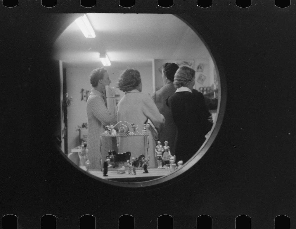 [Untitled photo, possibly related to: Shoppers at night in souvenir store, Provincetown, Massachusetts]. Sourced from the…