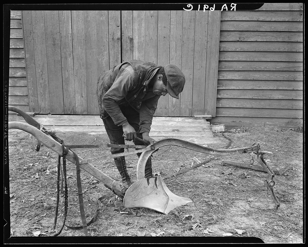 Mending a plow which has been bought through funds advanced by the Resettlement Administration. Virginia. Sourced from the…