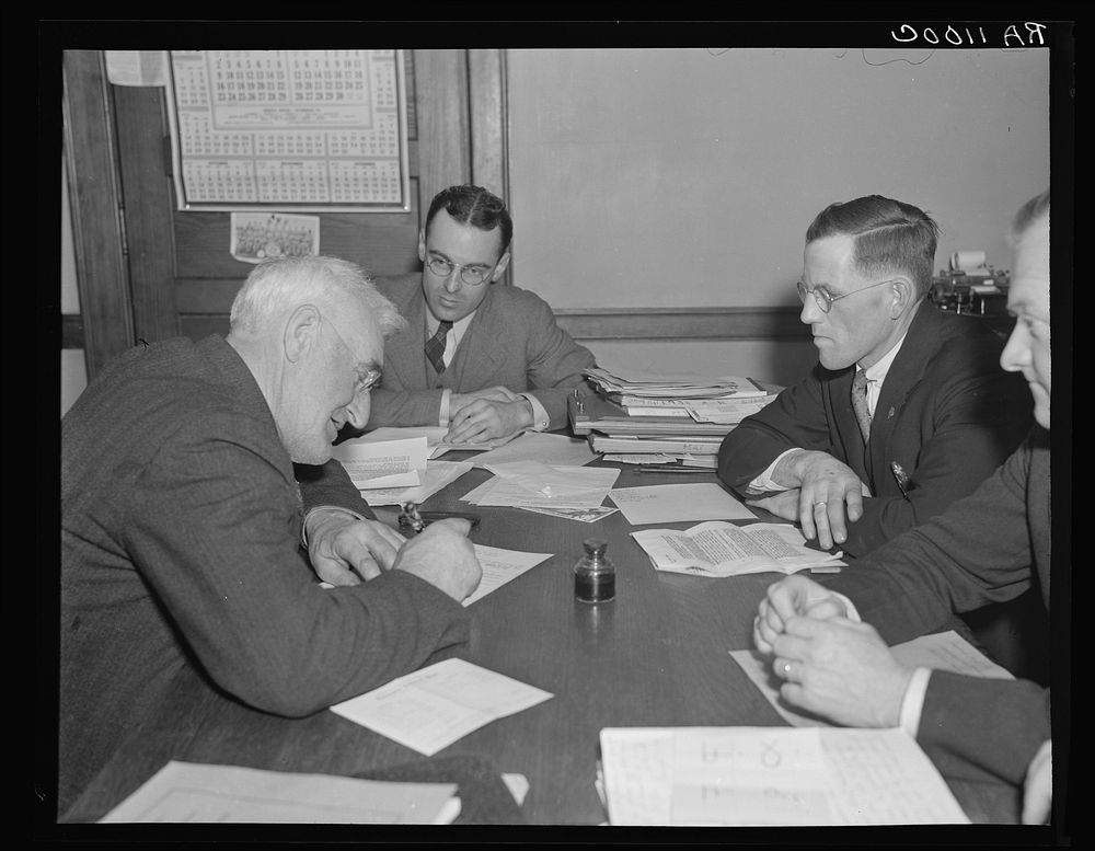 Farmer signing agreement with farmers' production cooperative. Coos County, New Hampshire. Sourced from the Library of…