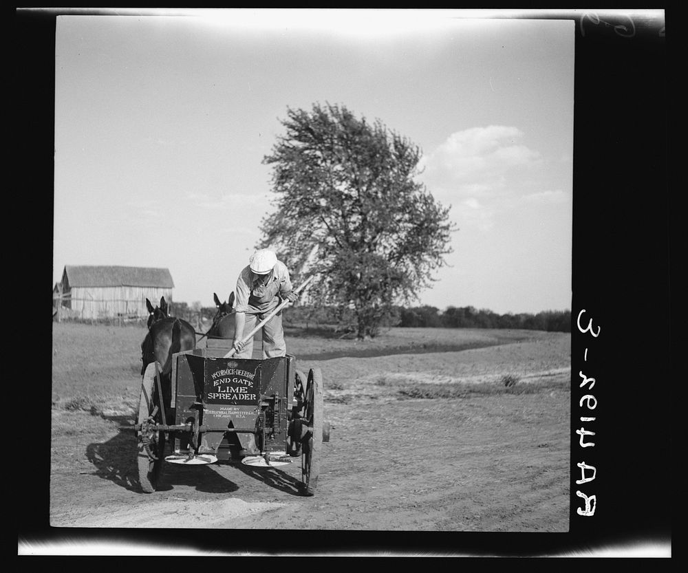 Rehabilitation client operating a lime spreader bought cooperatively through rehabilitation loan. Kansas. Sourced from the…