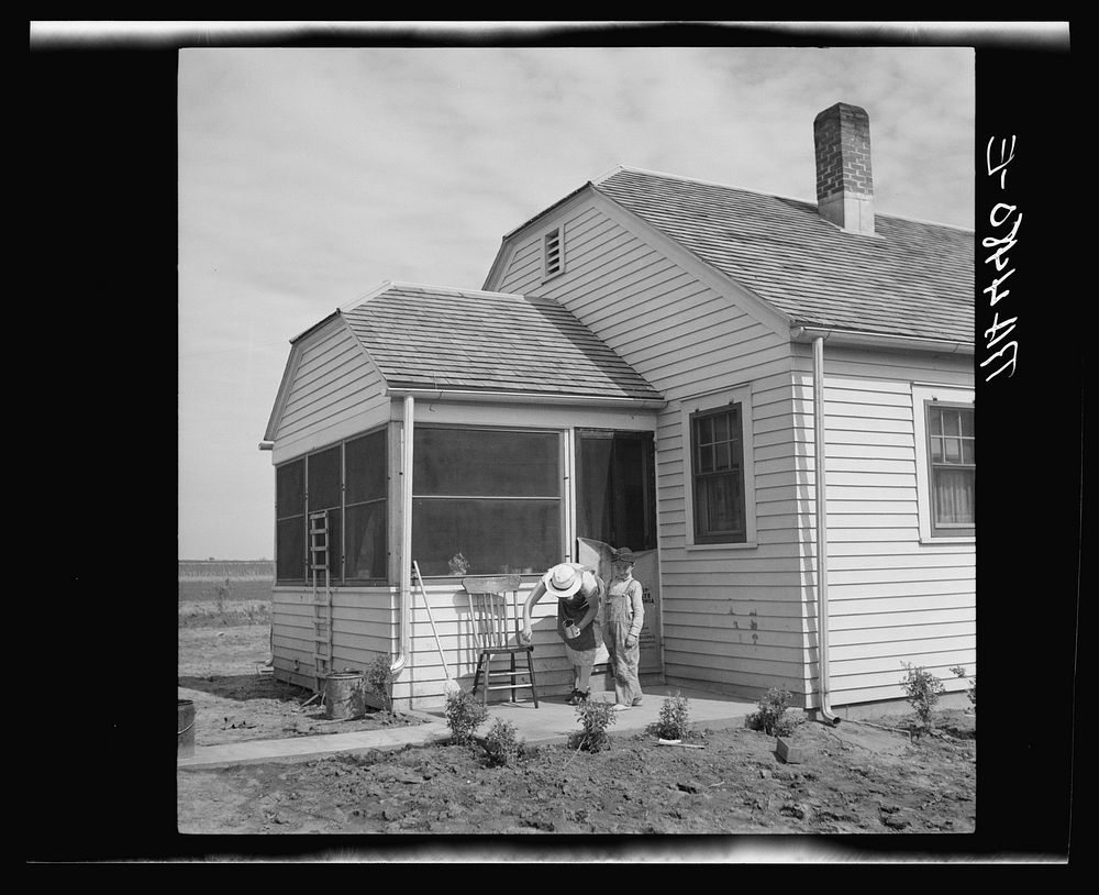 Farmsteader's wife painting kitchen furniture. Falls City Farmsteads, Nebraska. Sourced from the Library of Congress.