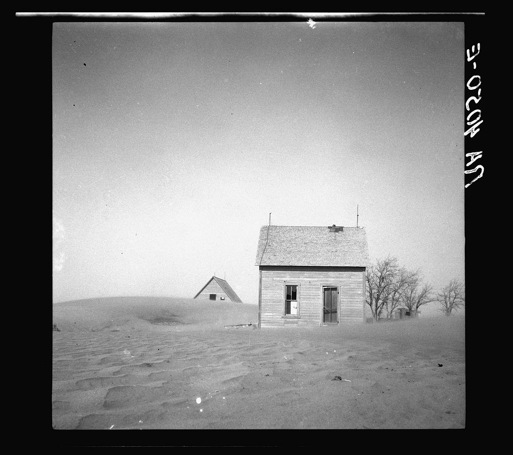 Sand whirling around house and barn. Cimarron County, Oklahoma. Sourced from the Library of Congress.