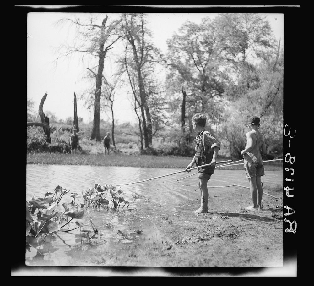 Rehabilitation client's children fishing in creek. Cherokee County, Kansas. Sourced from the Library of Congress.