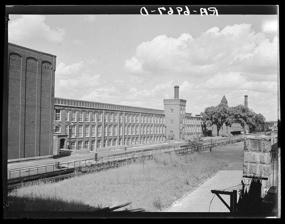 Amoskeag mills looking north from Bridge Street on Canal Street side. Manchester, New Hampshire. Sourced from the Library of…