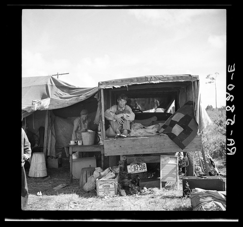Family from New Mexico, camped near the packinghouse at Deerfield, Florida. Note the box labeled "Yakima apples" which has…