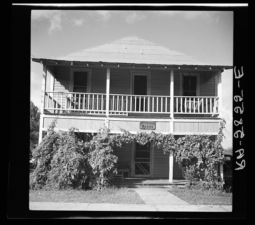 House across the street from the large packing plant in Winterhaven, Florida. Unmarried fruit workers room here. Sourced…