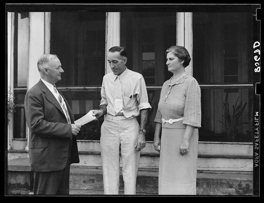 Presenting L.H. Adams with check for five thousand dollars. Adams was the first farmer in Region I to receive a loan under…