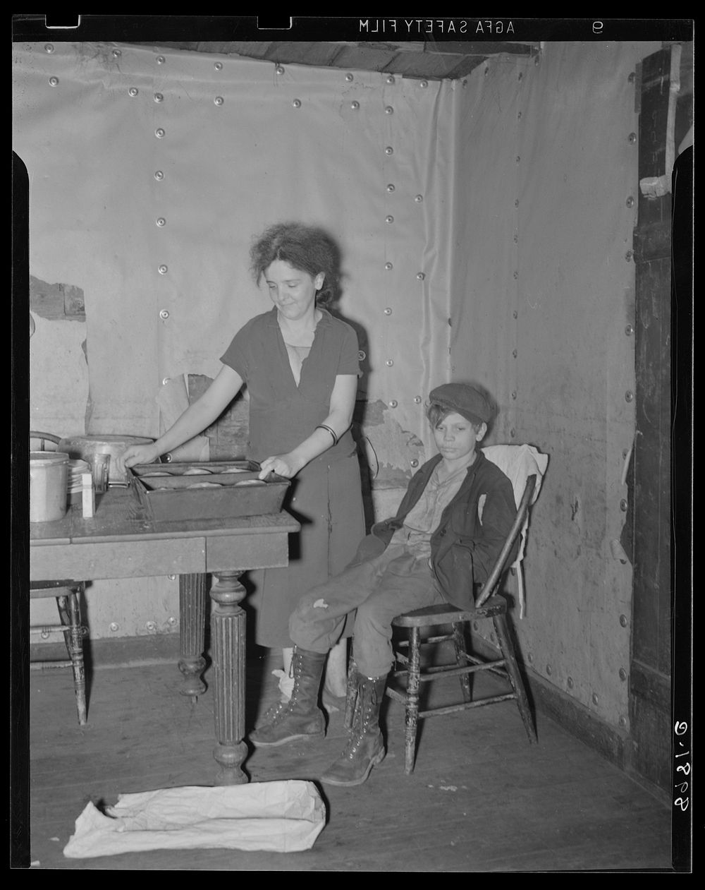 Wife and son of coal miner in kitchen of their home. Kempton, West Virginia. Sourced from the Library of Congress.