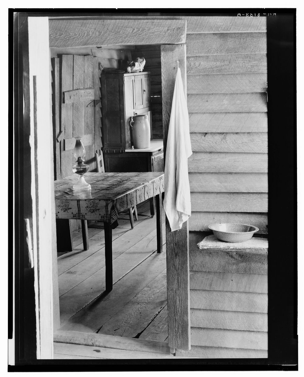 Washstand in the dog run and kitchen of Floyd Burroughs' cabin. Hale County, Alabama. Sourced from the Library of Congress.