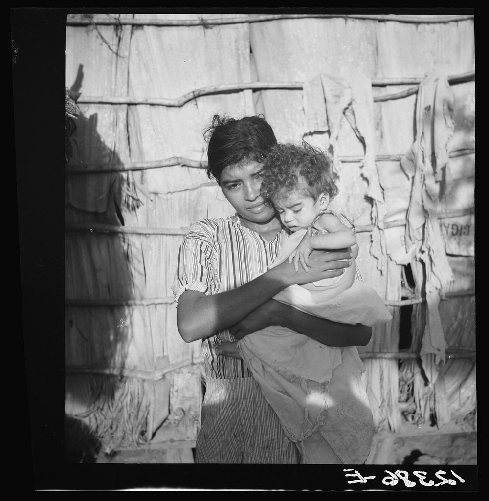 Wife and child of Jibaro tobacco worker near Cidra, Puerto Rico. Sourced from the Library of Congress.