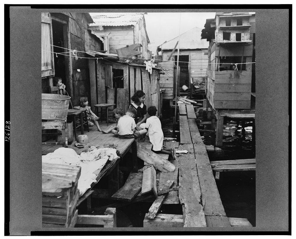 Shacks built over tidal swamp in the workers' quarter of Porta de Tierra. San Juan, Puerto Rico. Sourced from the Library of…