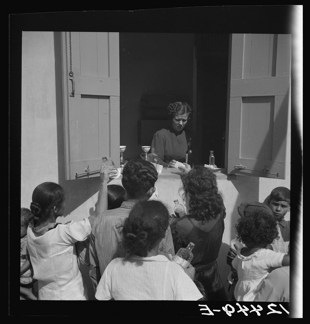 Distribution of free medicine outside a P.R.R.A. (Puerto Rico Resettlement Administration) health center. San Juan, Puerto…