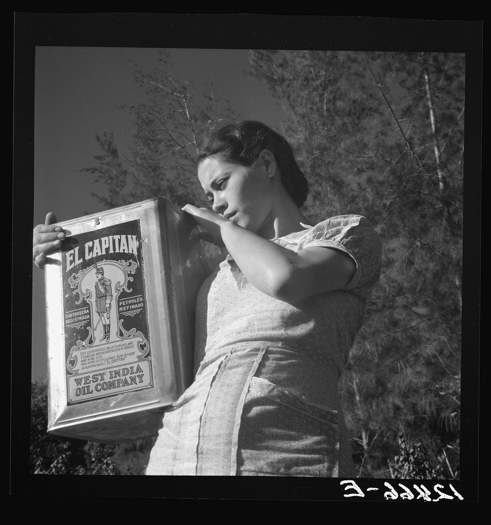 Girl carrying water; the gasoline can is one of the most valued utensils, especially in the hills. Puerto Rico. Sourced from…