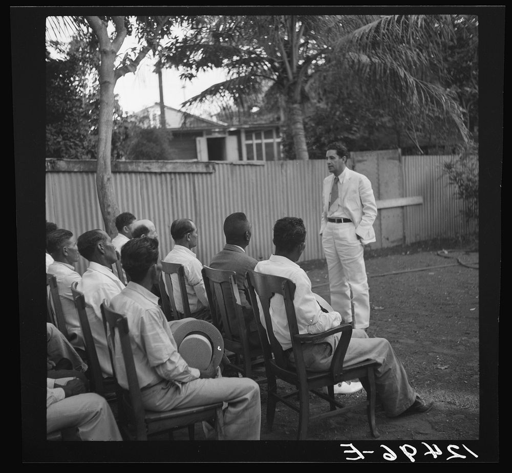Members of sugar refinery cooperative being addressed by project manager. Central Lafayette, Puerto Rico. Sourced from the…