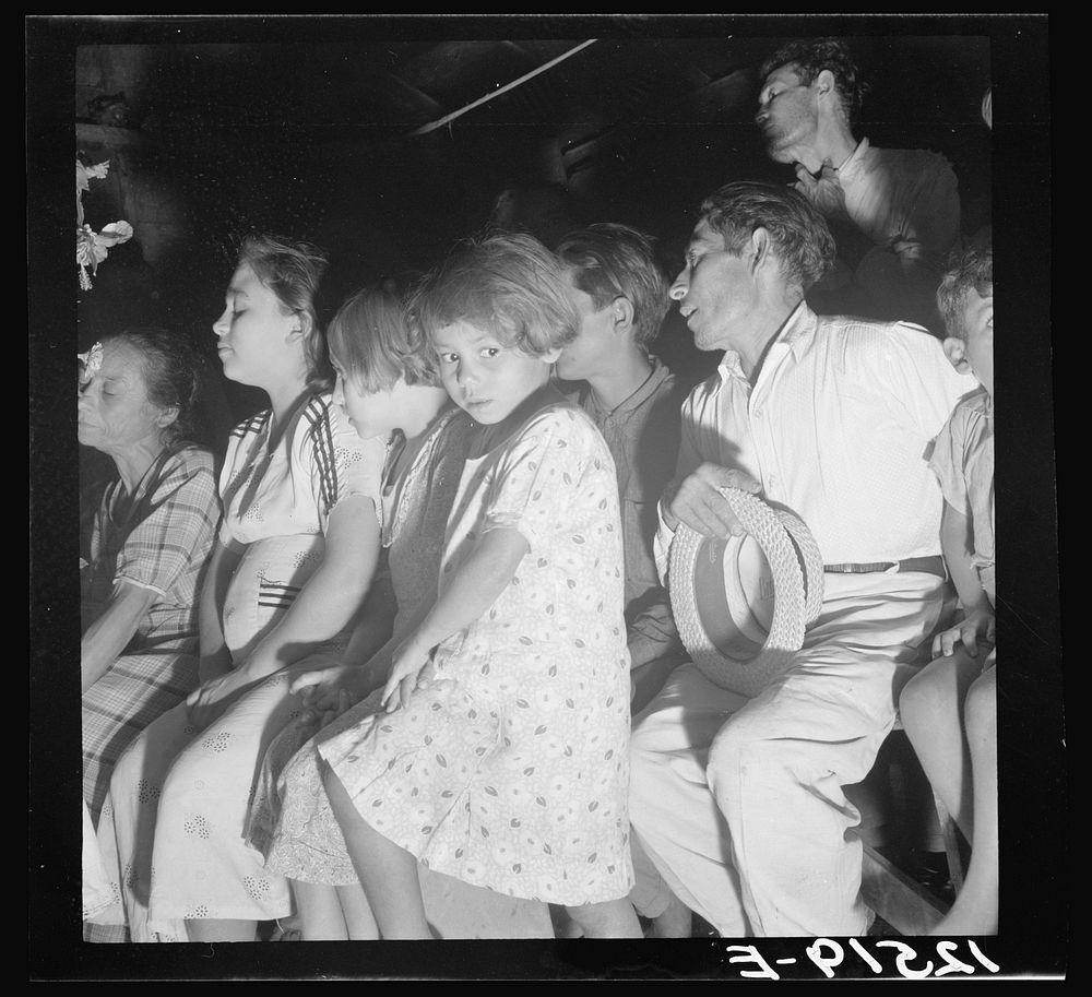 Audience at a "rosario," a semi-religious ceremony used for "cures" among the Hibaros. Near Cidra, Puerto Rico. Sourced from…