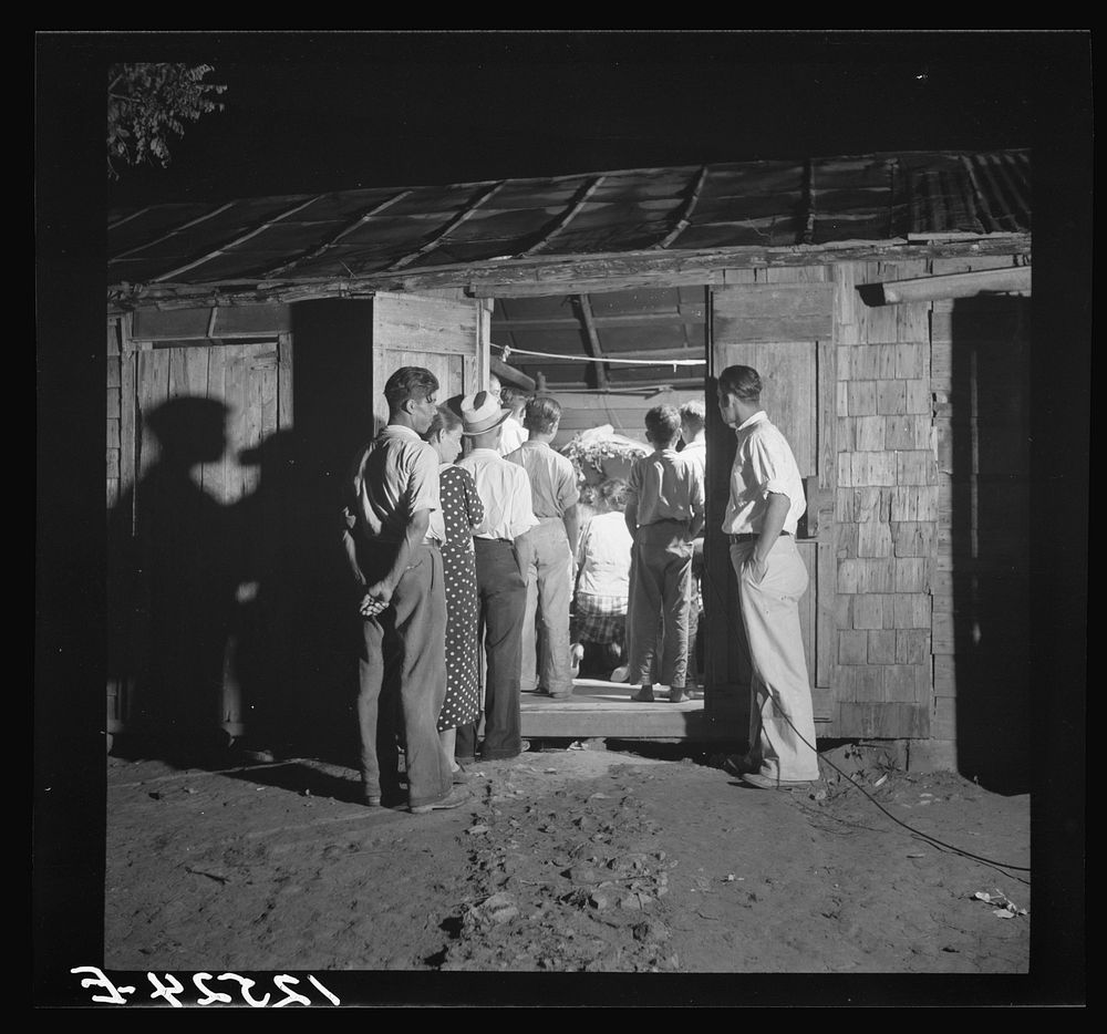 Rosario, a religious ceremony perported to have medicinal properties. A small altar is erected in the hut, all the neighbors…