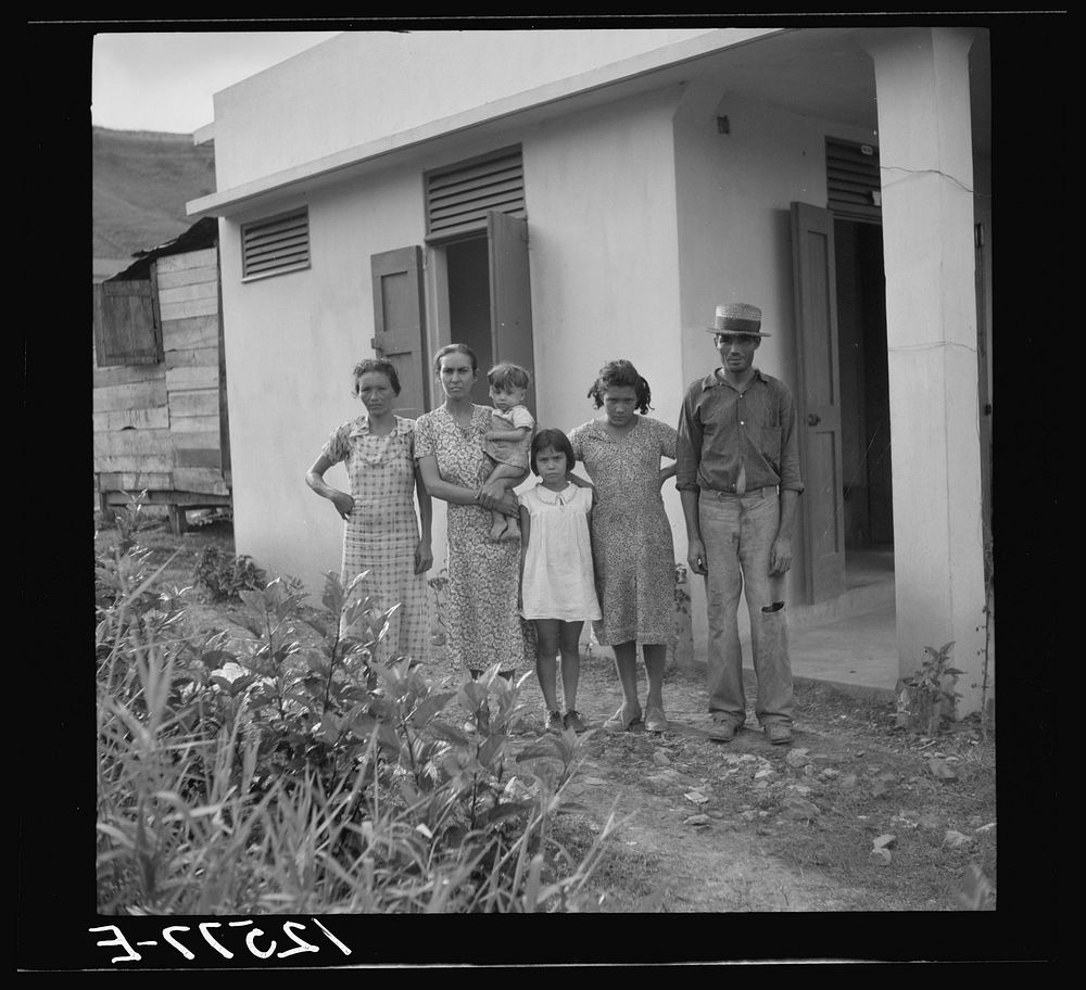 A Puerto Rican family of 5.2. A resettler's family in front of their hurricane-proof house on La Plata project. Puerto Rico.…