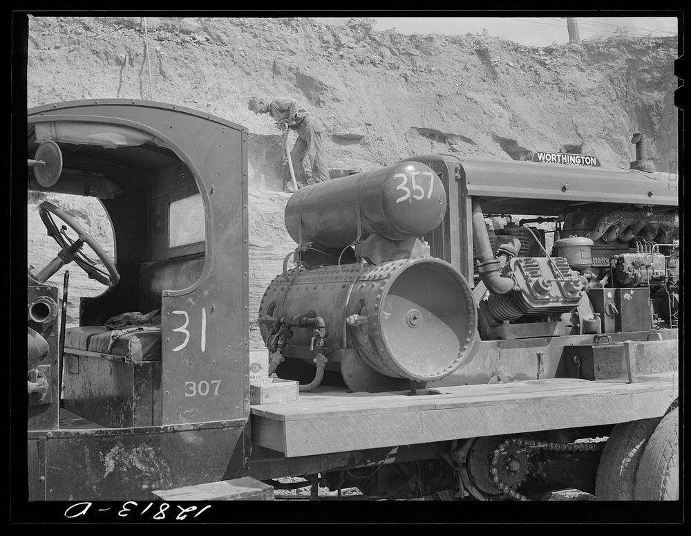 Compressor truck and quarry worker. Limestone quarry near Frederick, Maryland. Sourced from the Library of Congress.