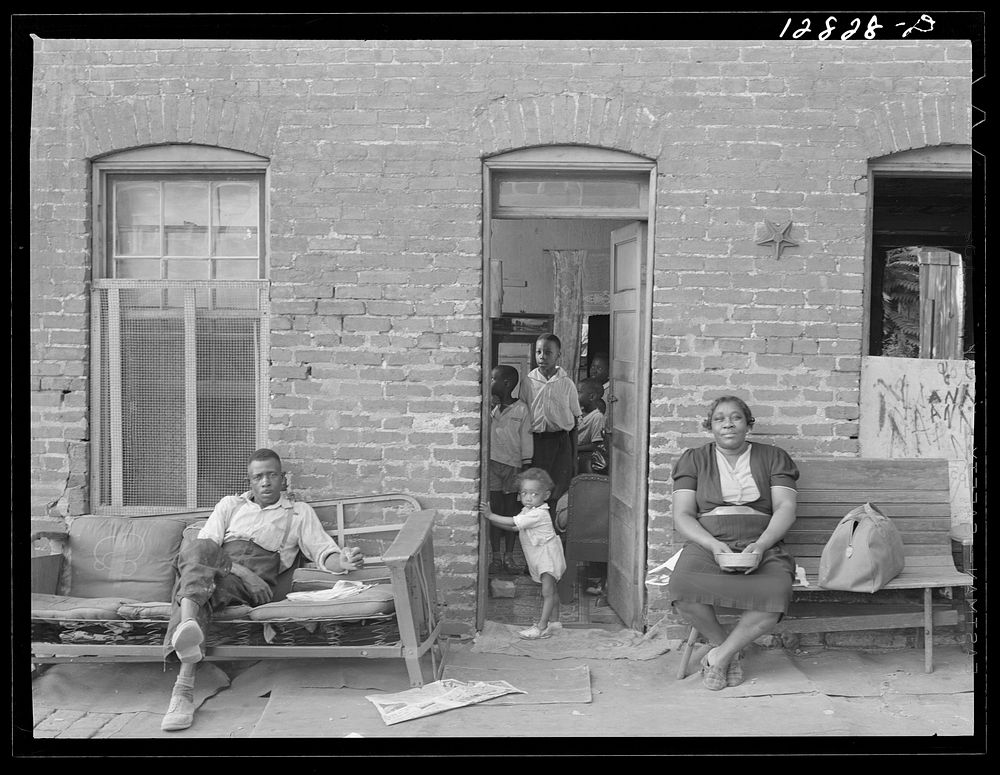 family and their home in one of the alley dwelling sections. Washington, D.C.. Sourced from the Library of Congress.