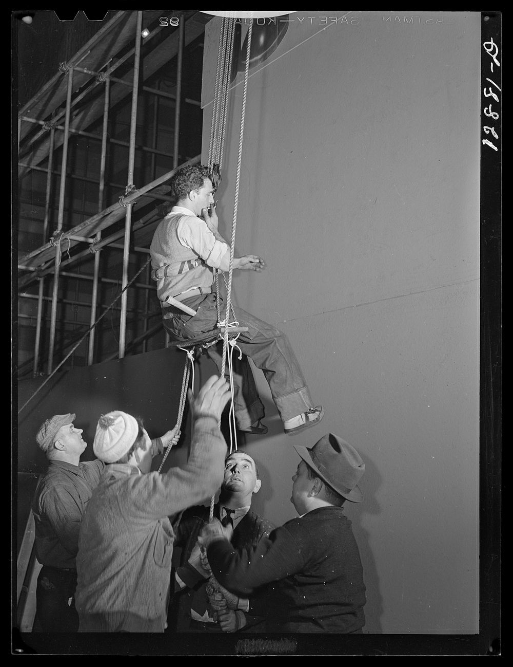 New York, New York. Installing the defense bond sales photomural, prepared by  the Farm Security Administration, in the…