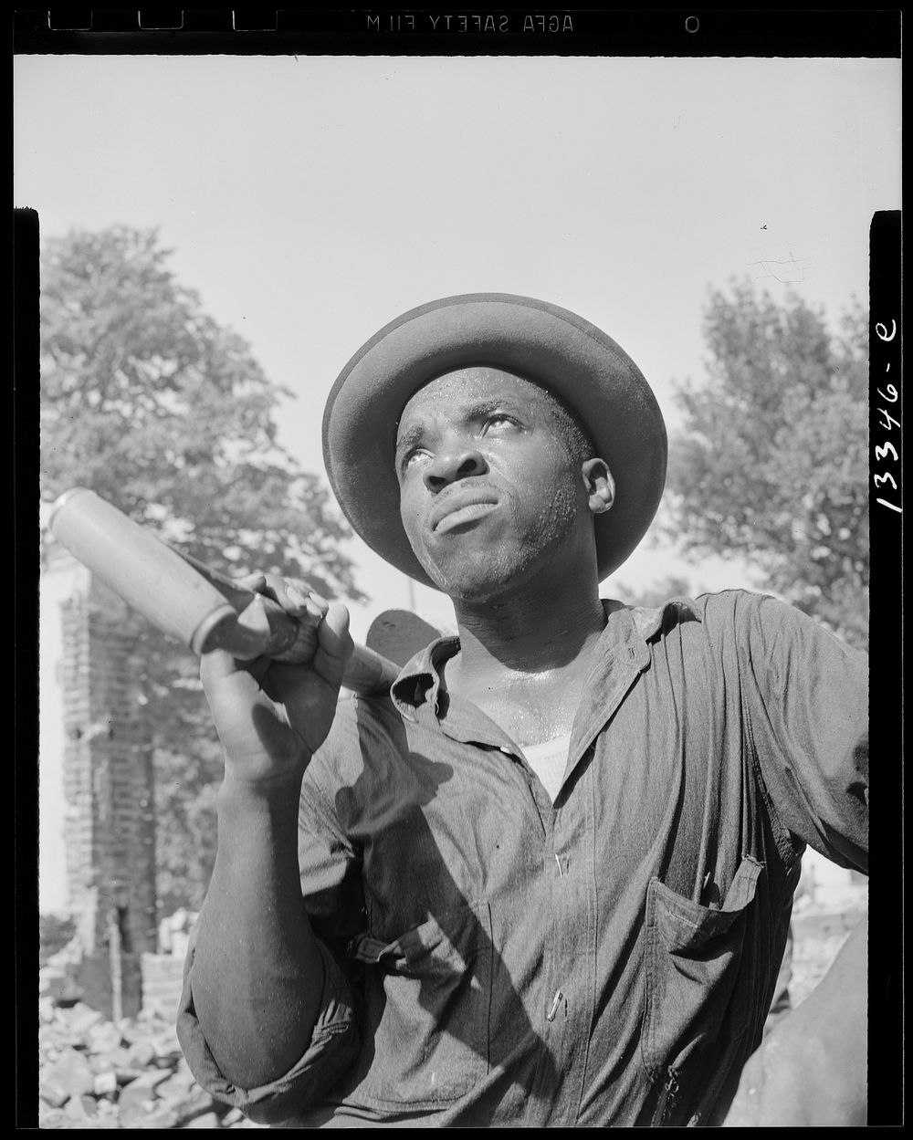 Washington, D.C. Laborer listening to instructions of wrecking company foreman on Independence Avenue. Sourced from the…