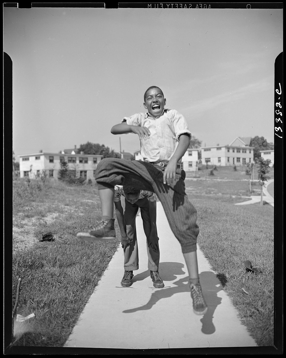 Anacostia, D.C. Frederick Douglass housing project. Boys playing leap frog near the project. Sourced from the Library of…