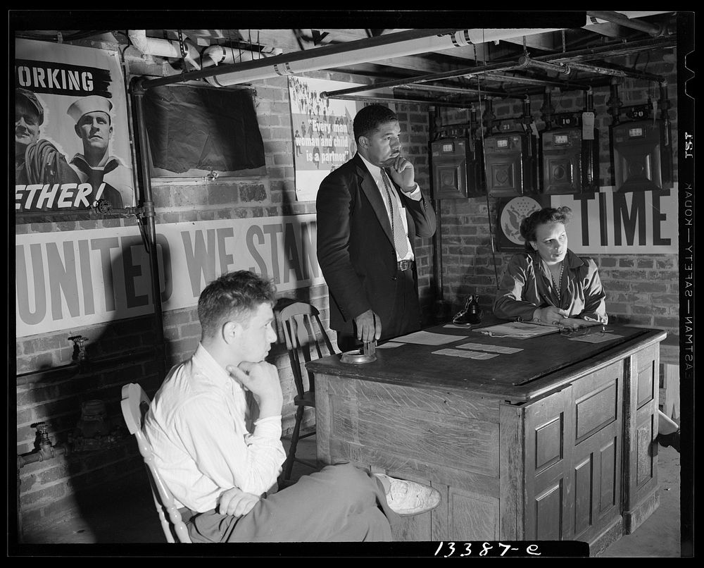 Washington, D.C. Air raid wardens' meeting in zone nine, Southwest area. Mr. Douglas Frederick, who is a firewatcher at the…