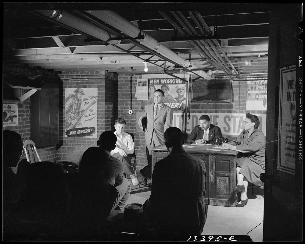 Washington, D.C. Air raid wardens' meeting in zone nine, Southwest area. Elmer House, federal worker by day and an air raid…