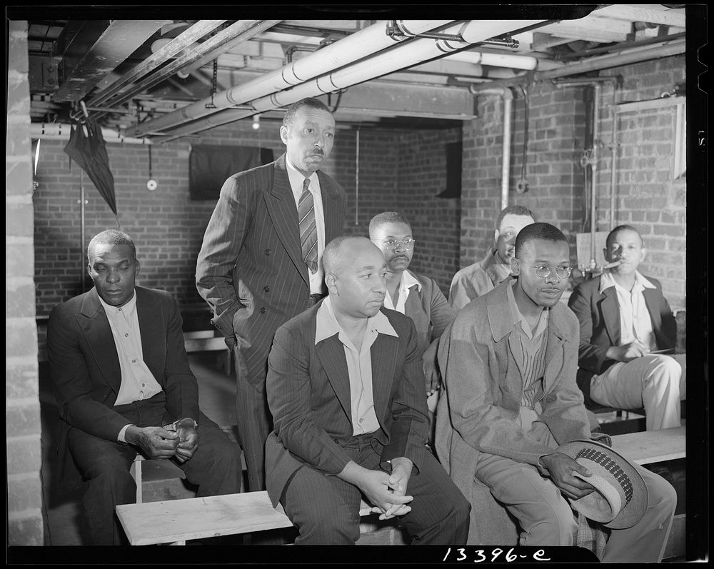 Washington, D.C. Air raid wardens' meeting in zone nine, Southwest area. Mr. Barton, a sector warden, reporting to the…
