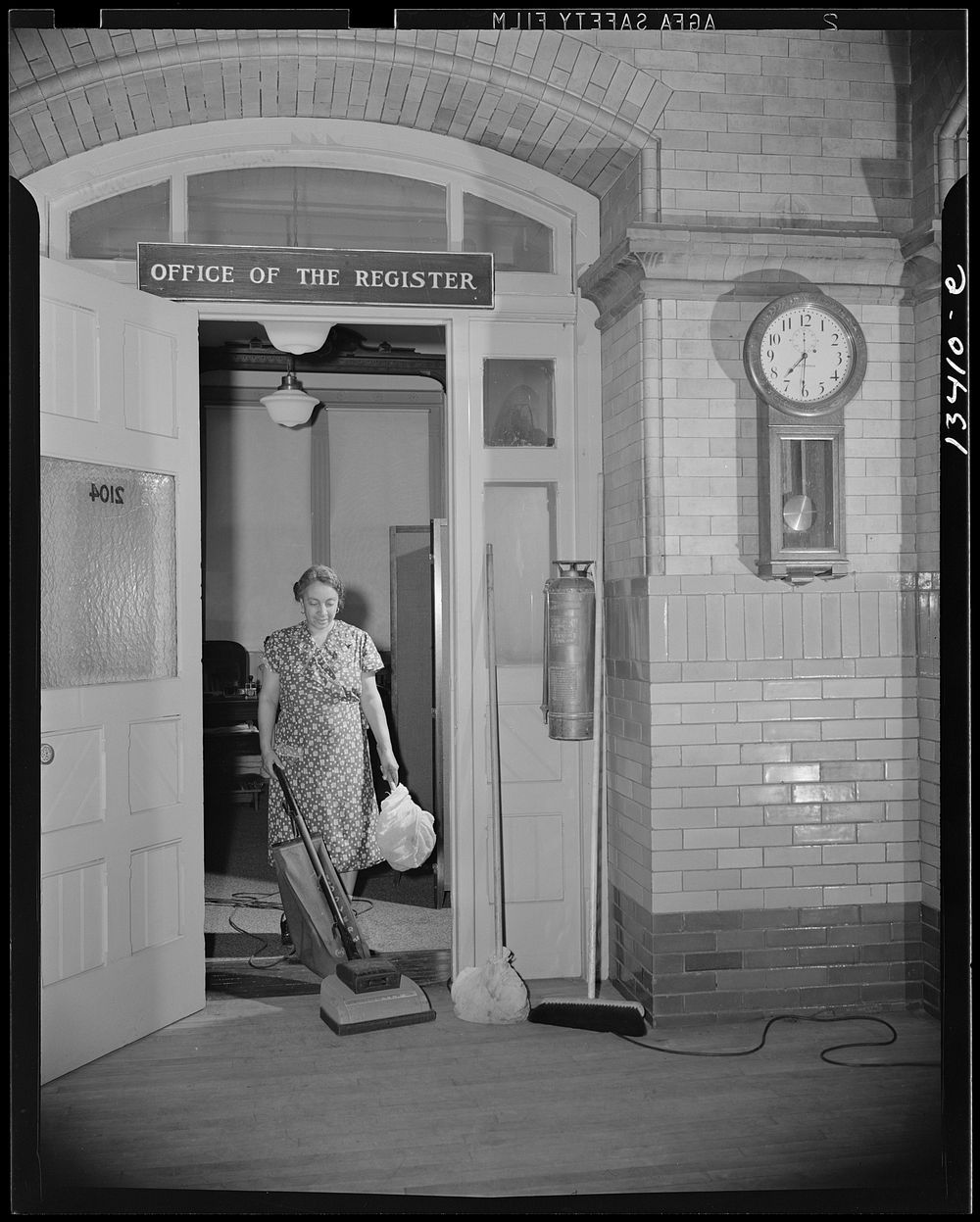 Washington, D.C. Government charwoman cleaning after regular hours. Sourced from the Library of Congress.