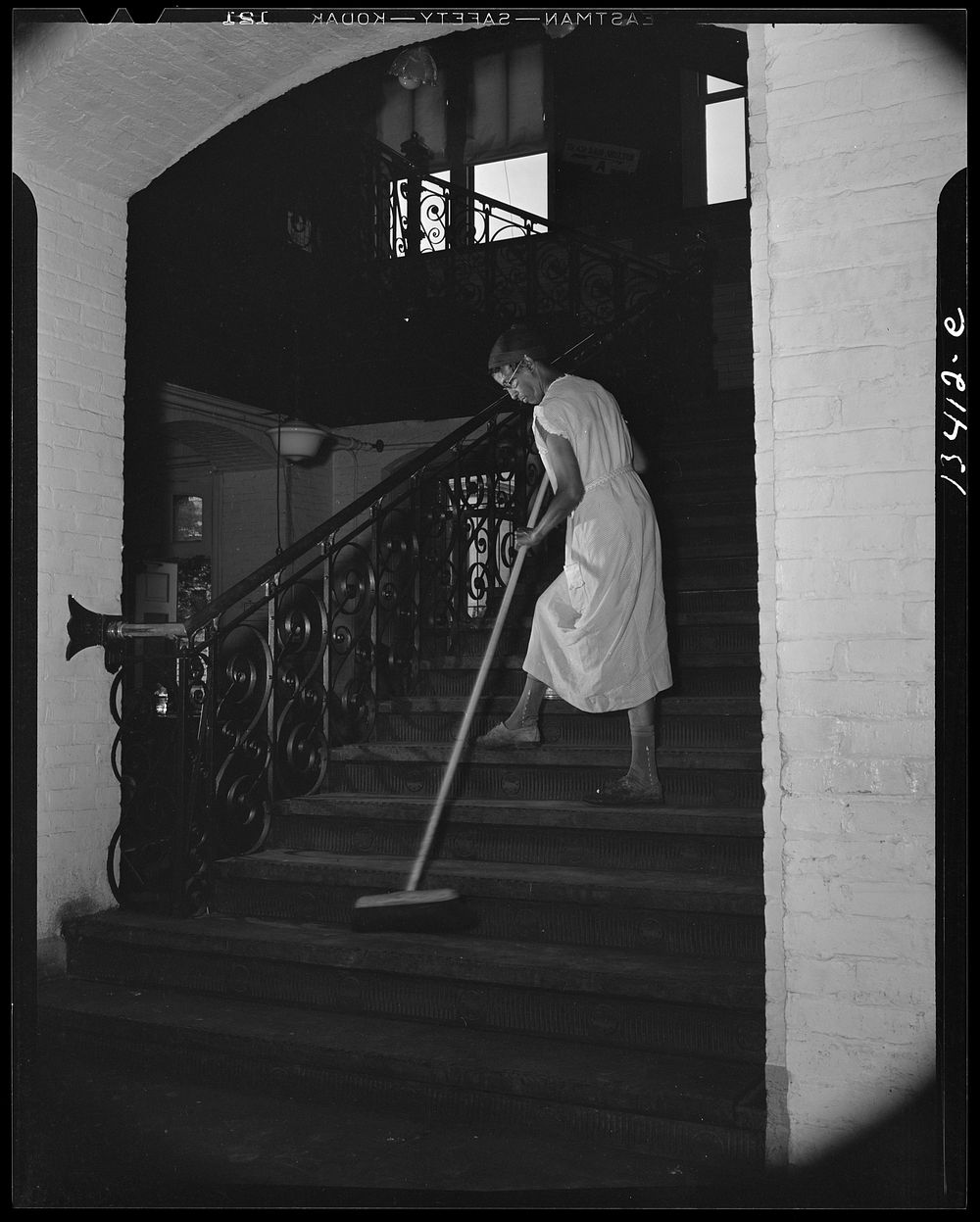 Washington, D.C. Government charwoman cleaning after regular working hours. Sourced from the Library of Congress.