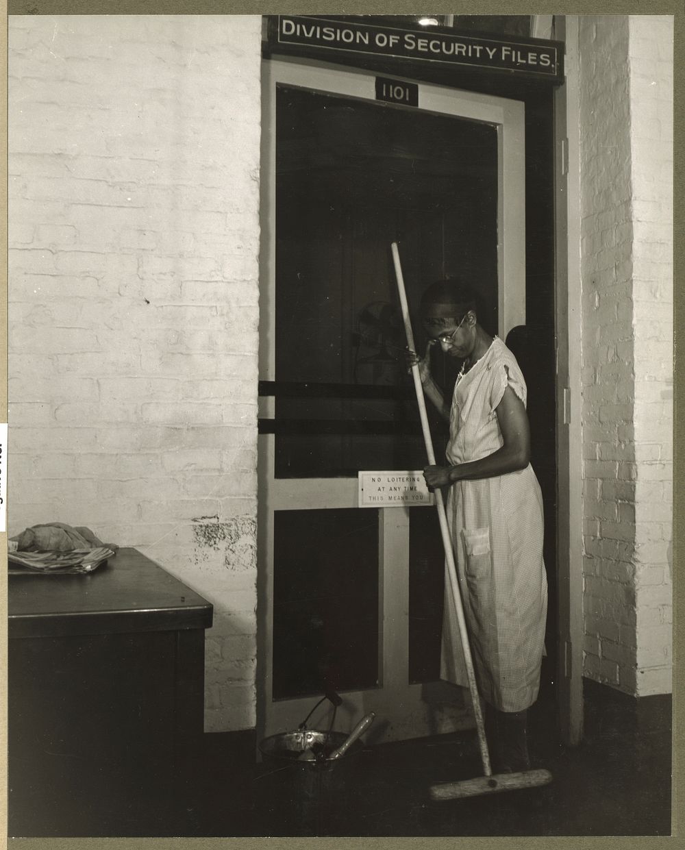 Washington, D.C. Government charwoman cleaning after regular working hours. Sourced from the Library of Congress.