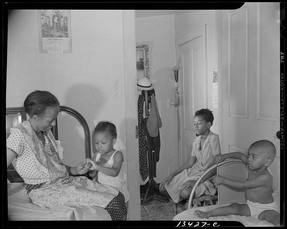 Washington, D.C. Adopted daughter and two grandchildren with Mrs. Ella Watson, a government charwoman. Sourced from the…