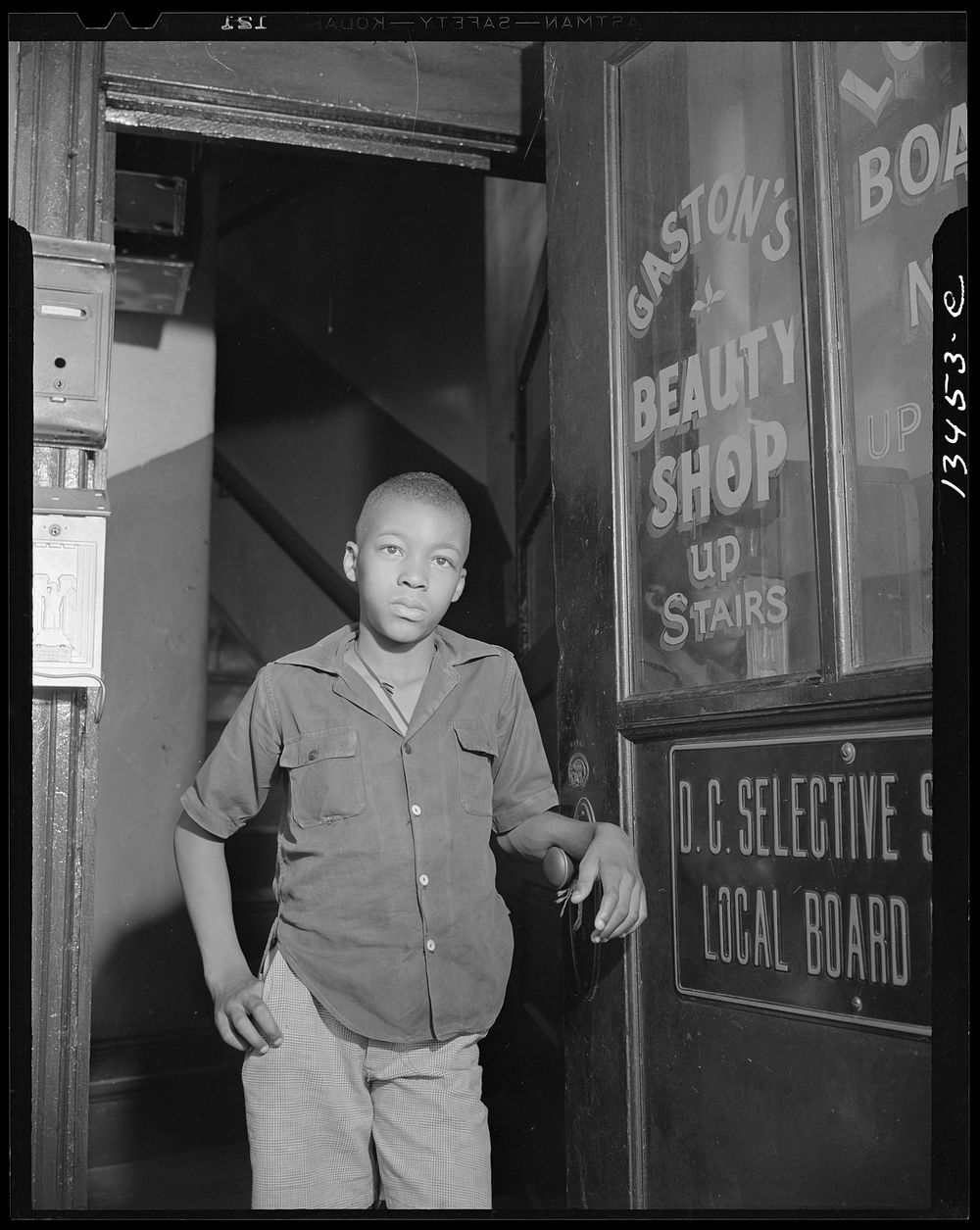 Washington, D.C. Youth waiting for a newspaper delivery truck. Sourced from the Library of Congress.