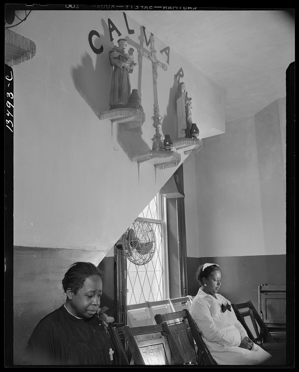 Washington, D.C. Sitting beneath the emblem of the crucifixion of Jesus on Calvary. Two members of the St. Martin's…