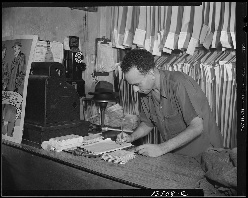 Washington, D.C. A tailor in Frank's cleaning and pressing establishment checking over the days intake. Sourced from the…
