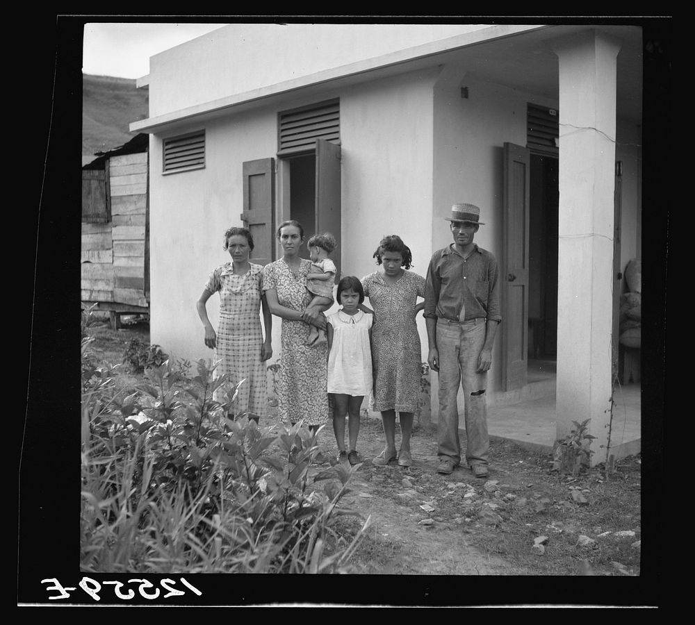 [Untitled photo, possibly related to: A Puerto Rican family of 5.2. A resettler's family in front of their hurricane-proof…