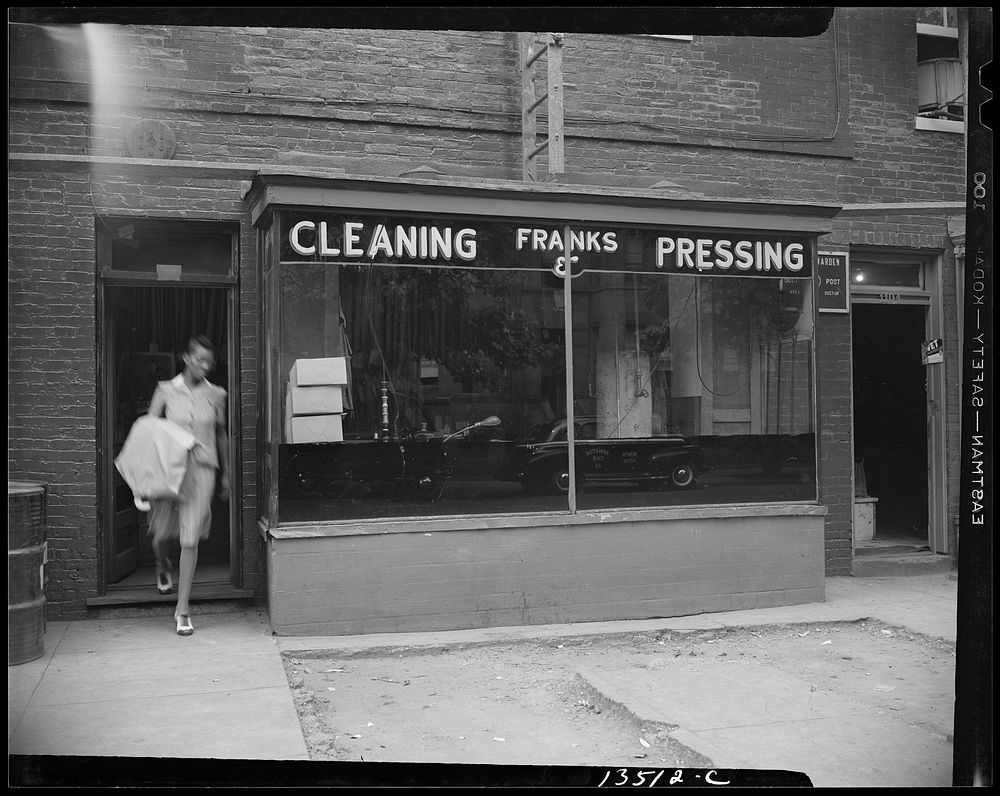 [Untitled photo, possibly related to: Washington, D.C. A tailor in Frank's cleaning and pressing establishment checking over…