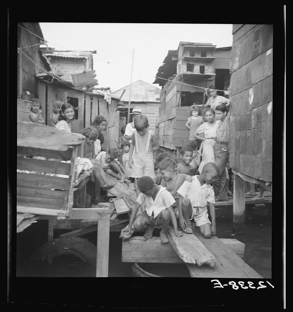 [Untitled photo, possibly related to: Shacks built over tidal swamp in the workers' quarter of Porta de Tierra. San Juan…
