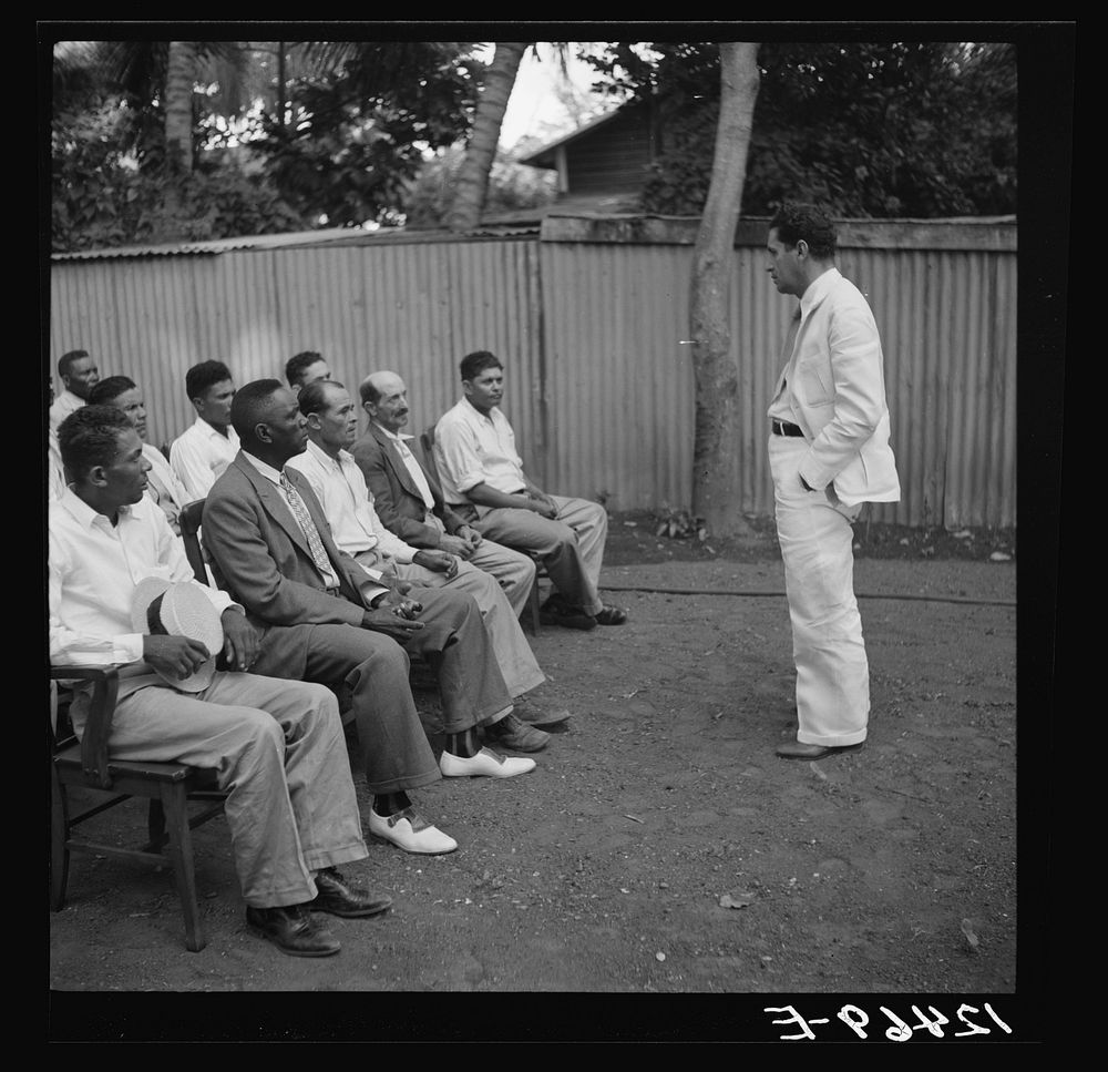 [Untitled photo, possibly related to: Members of sugar refinery cooperative being addressed by project manager. Central…