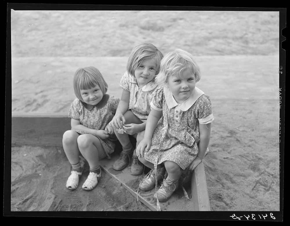 Children playing in sandbox. Tulare migrant camp. Visalia, California. Sourced from the Library of Congress.