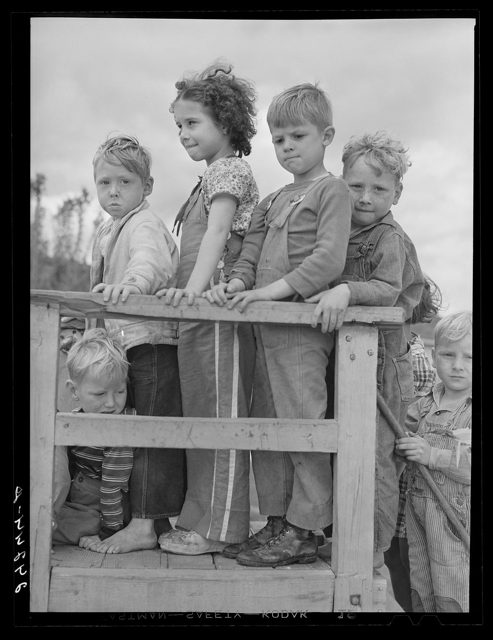 Children waiting their turn on slide. Shafter migrant camp. Shafter, California. Sourced from the Library of Congress.