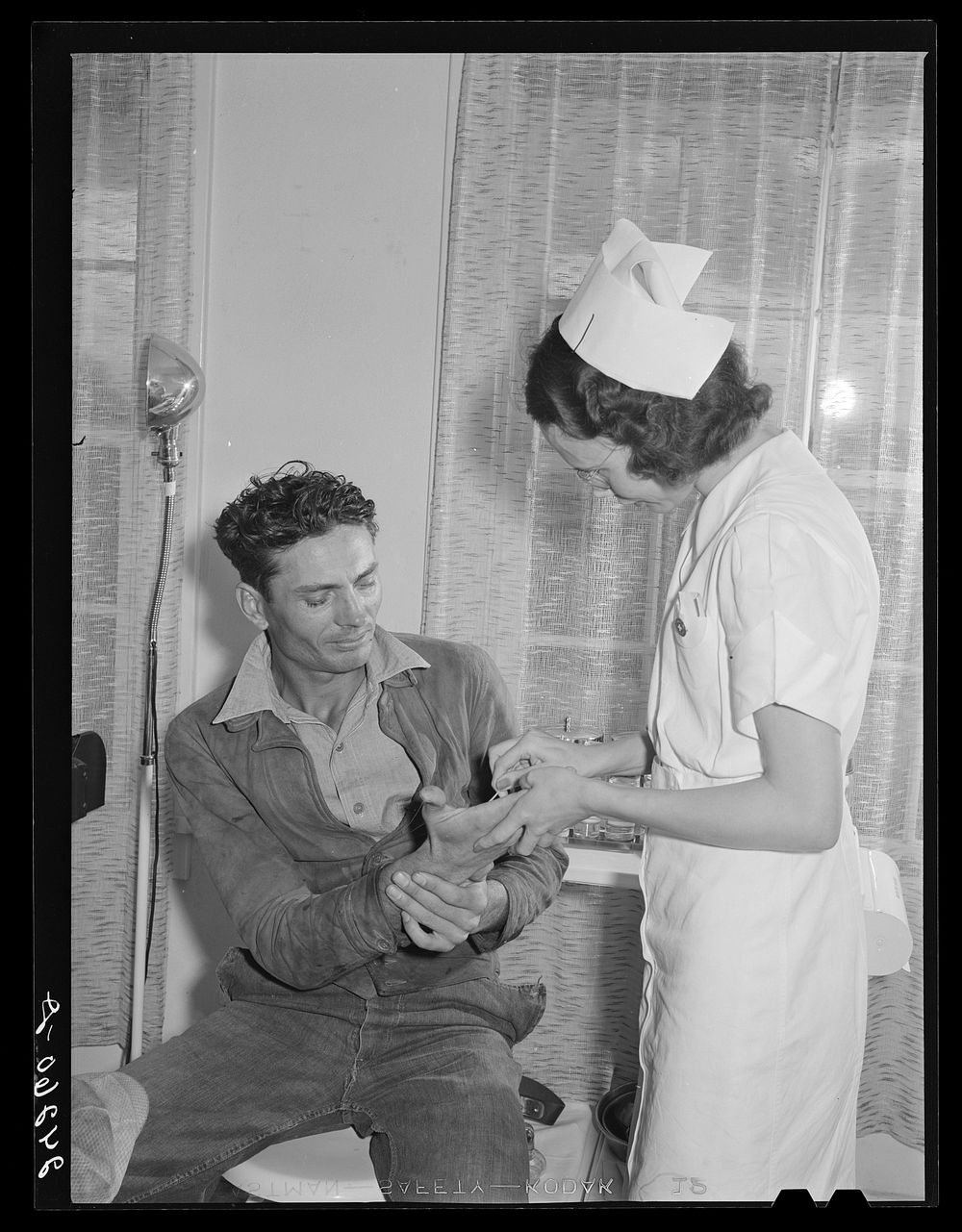 Patient receiving medical aid in health clinic. Shafter migrant camp. Shafter, California. Sourced from the Library of…