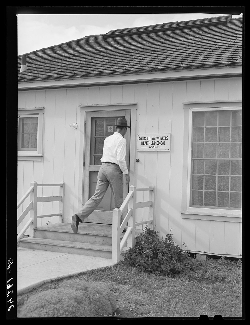 Patient entering health clinic. Shafter migrant camp. Shafter, California. Sourced from the Library of Congress.