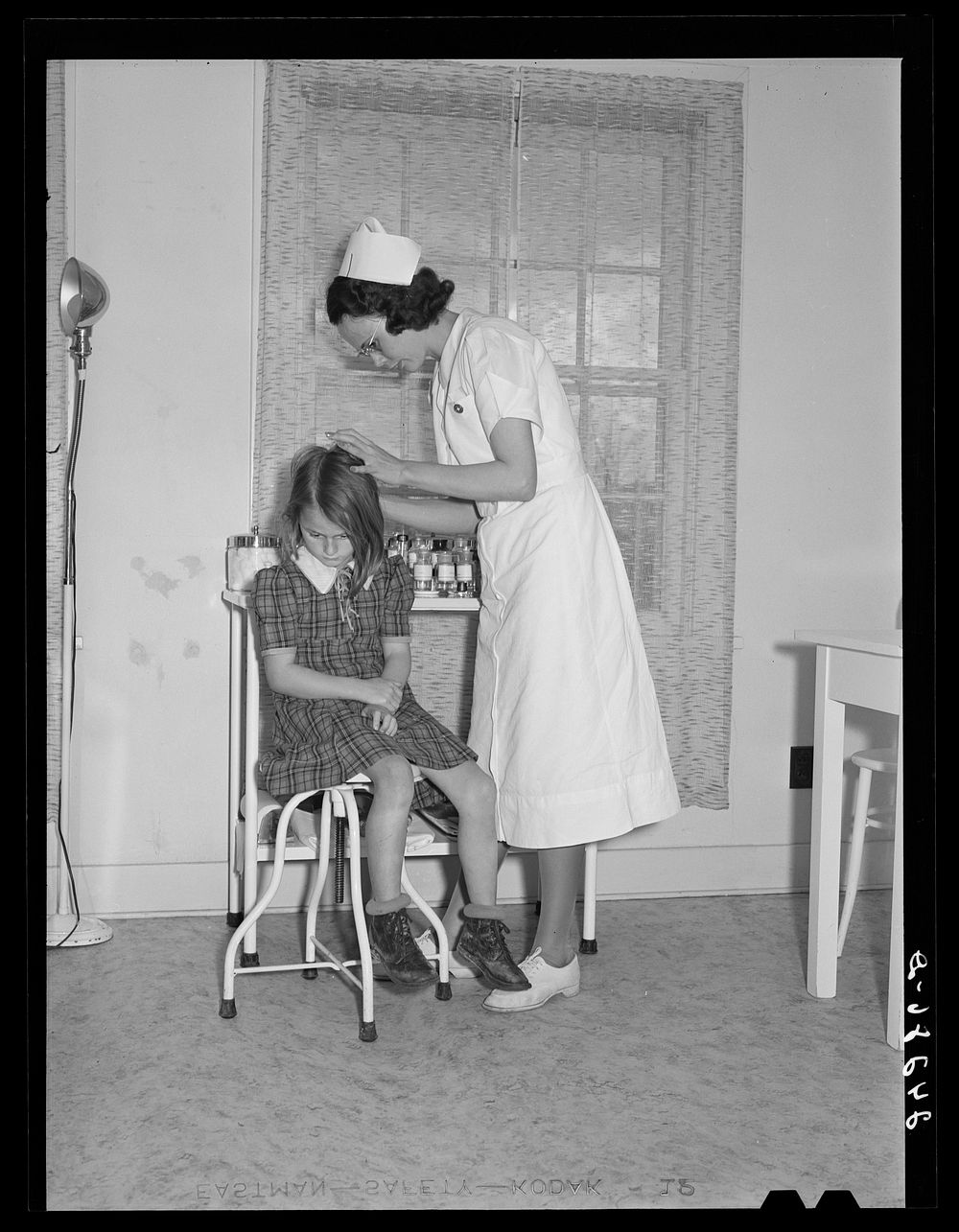 Child being treated in health clinic. Shafter migrant camp. Shafter, California. Sourced from the Library of Congress.