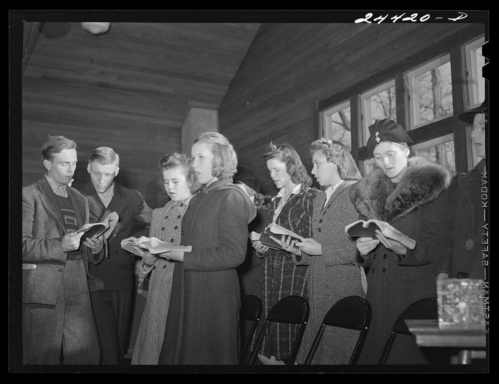 Group singing hymns at the opening of the Sunday school. While there are no churches on the project there are five or six in…